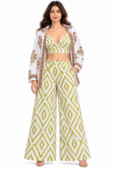 Model wearing the Olive Bloom three-piece co-ord set with crop top, floral shirt and palazzo